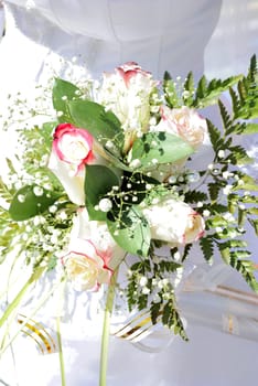 Beautiful white wedding bouquet in hands of the bride..