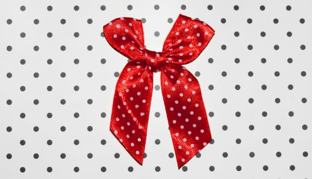 Red bow white circle on a white background in a black circle