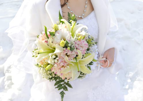 Beautiful wedding bouquet in hands of the bride.