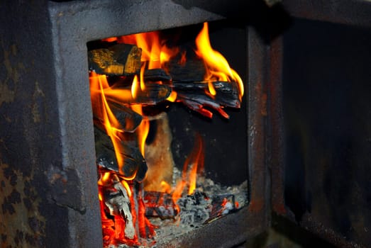 Burning fire wood in the brick furnace