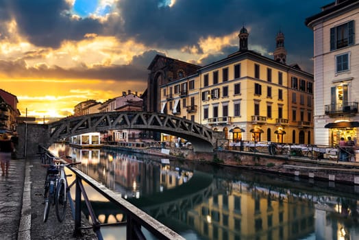 Bridge across the Naviglio Grande canal at the evening in Milan, Italy