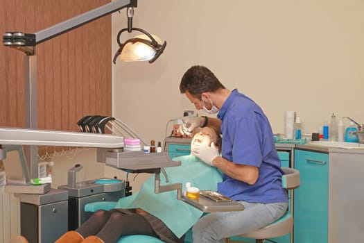 Dentist and Patient Girl in Dental Clinic