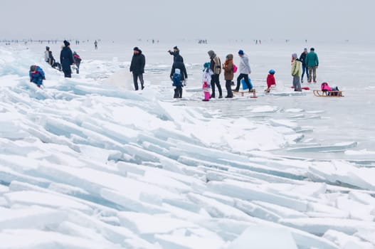 People walking and ice skating on the frozen Balaton Lake at Sifok, Hungary on 29th January, 2017