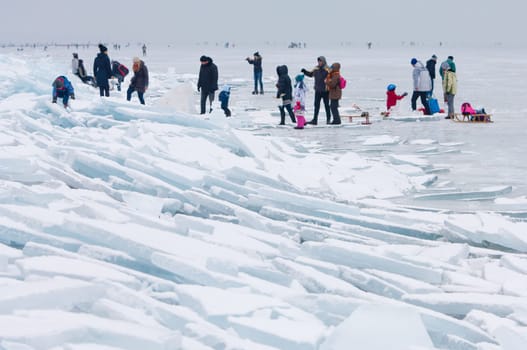 People walking and ice skating on the frozen Balaton Lake at Sifok, Hungary on 29th January, 2017