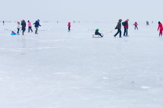 People walking and ice skating on the frozen Balaton Lake at Sifok, Hungary on 29th January, 2017