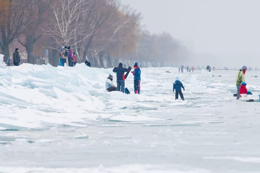 People walking and ice skating on the frozen Balaton Lake at Sifok, Hungary on 29th January, 2017