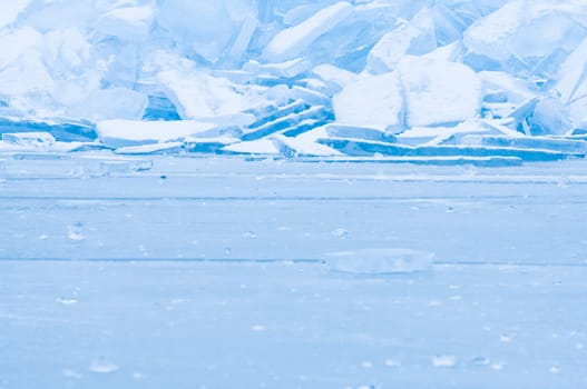 Winter scene at a frozen lake with ice-pack and other ice formations