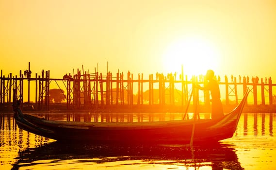 Fishman under U bein bridge at sunset, Myanmar landmark in mandalay