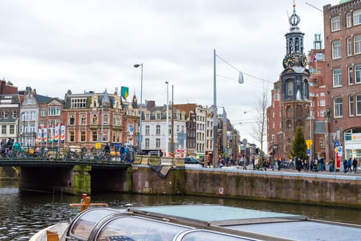Amsterdam, Netherlands - January 9, 2017: Street view with traditional Dutch row houses and famous canals in Amsterdam historical city center, the Netherlands’ capital, known for its artistic heritage