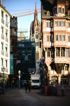 Frankfurt,Germany - January 05,2017: A narrow alley with a view of Frankfurt Cathedral between the historic buildings of the Römerberg on January 5,2017 in Frankfurt.
