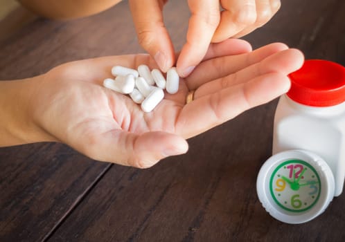 White pills medicine headache on hand, stock photo