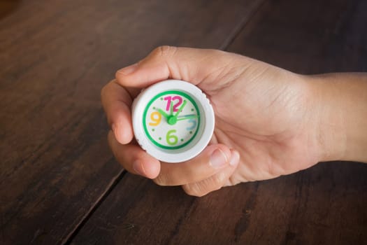 Mini white clock in hand, stock photo
