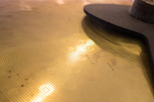 Metallic drum plate in white room, stock photo