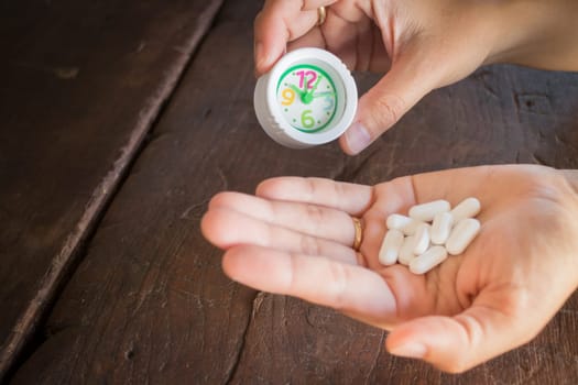 White pills medicine headache on hand, stock photo