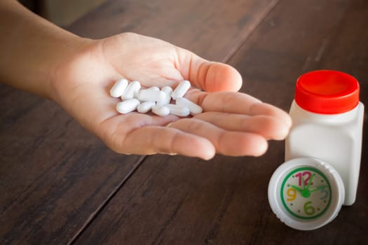 White pills medicine headache on hand, stock photo