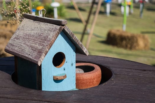 Wooden bird house decorated on the table, stock photo