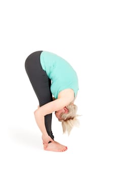 Full-body view of a young blonde woman during yoga exercise "Standing Prevention"" Step 3 against a white background with a slight shadow"