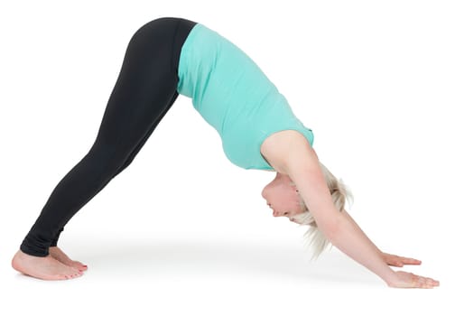 Full-body view of a young blonde woman doing yoga exercises against a white background with a slight shadow