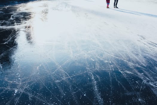 Surface of outdoor ice with skaters, replete with skate marks. Ice background
