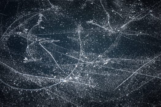 Surface of outdoor ice with snow, replete with skate marks. Abstract Ice background