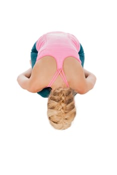Full body view of a young blonde woman in the yoga position "position of the child"" isolated on white in top view."