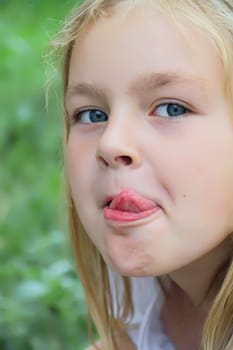 Portrait of beautiful girl with put out tongue