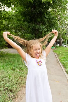 Cute beautiful girl makes faces imitate witch