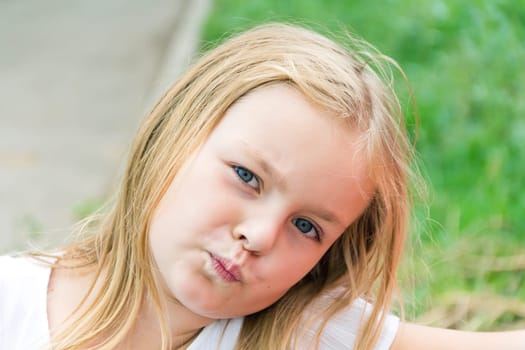 Cute girl with blond long hair and blue eyes