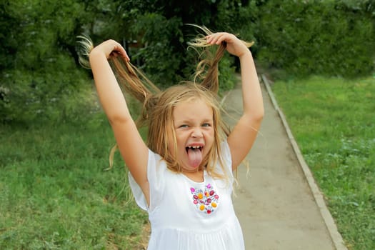 Portrait of girl with smile and makes faces