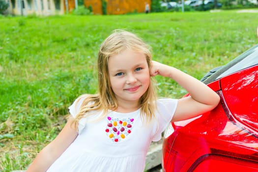 Cute girl with blond long hair and blue eyes