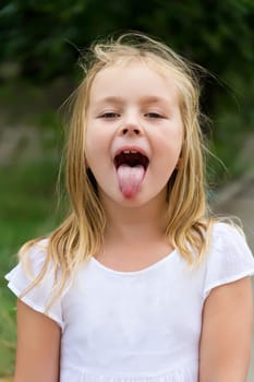 Portrait of cute girl with put out tongue