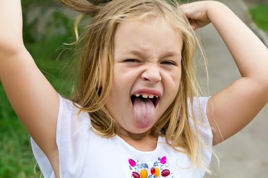 Cute beautiful girl makes faces imitate witch
