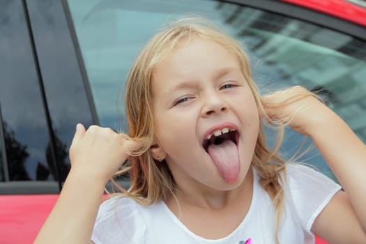 Portrait of girl with smile and makes faces