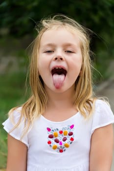 Portrait of cute girl with put out tongue