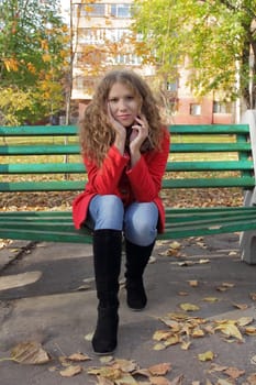 Portrait of thinking young woman in red coat