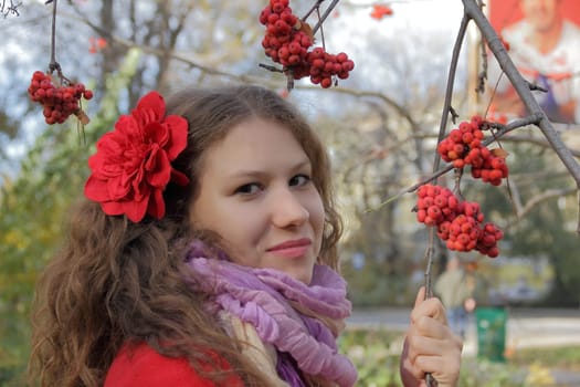 Image of beautiful young woman with autumn leaves