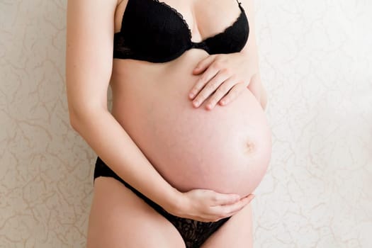 Image of pregnant woman in black underwear
