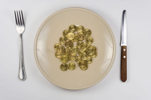 On the plate is a bunch of Russian ten-coin lying near tableware view from above