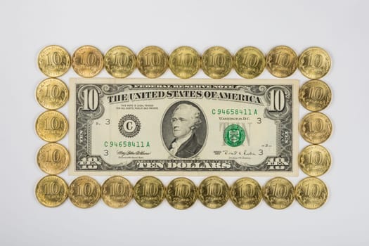 Ten dollars levied on the perimeter of a ten Russian coins, top view