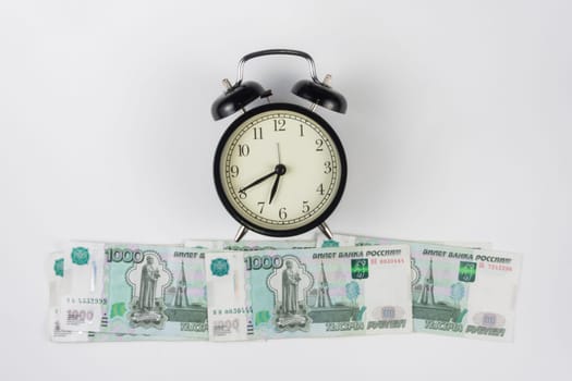 Table clocks are on the ruble thousandths bills, top view