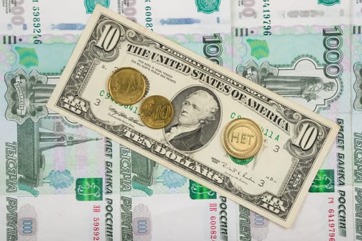 The coin with the inscription "no"" and the euro are on the bill of ten dollars which lies on a pile of thousand-Russian banknotes"