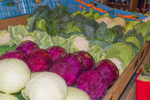 Different types of cabbage at a farmer's market..