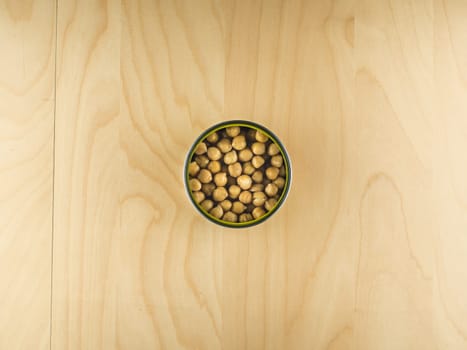 Top view of open tin can with chickpeas, simple dieting illustration