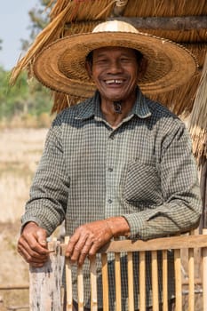 Portrait of an old Asian man with a straw hat