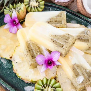 Homemade popsicles with pineapple,coconut and kiwi