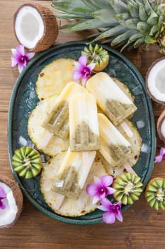 Homemade popsicles with pineapple,coconut and kiwi