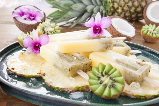 Homemade popsicles with pineapple,coconut and kiwi