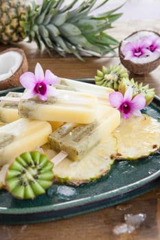 Homemade popsicles with pineapple,coconut and kiwi