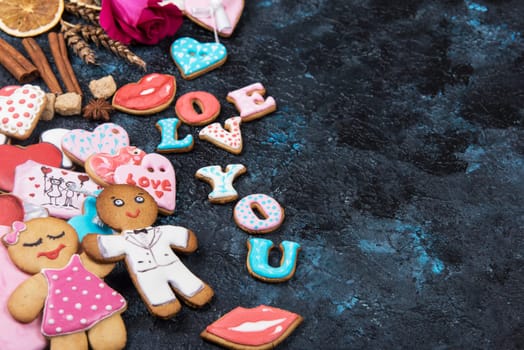 Gingerbreads for Valentines Day on dark concrete background