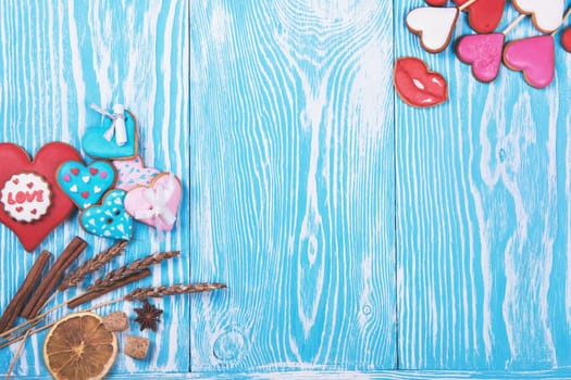 Gingerbreads for Valentines Day or wedding theme on blue wooden background